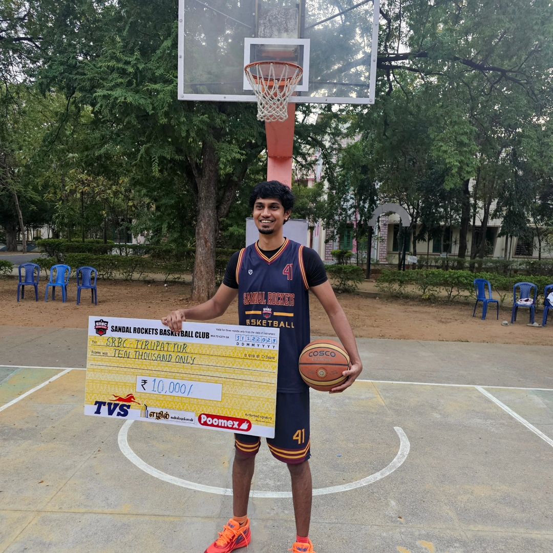 Holding a basketball trophy